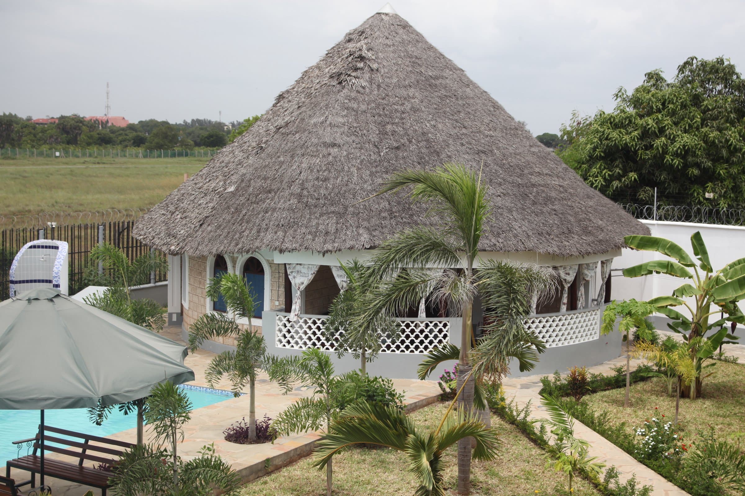 Exterior of a Two-Bedroom Family Cottage with traditional Makuti thatched roof, coral-stone walls and Swahili architectural details